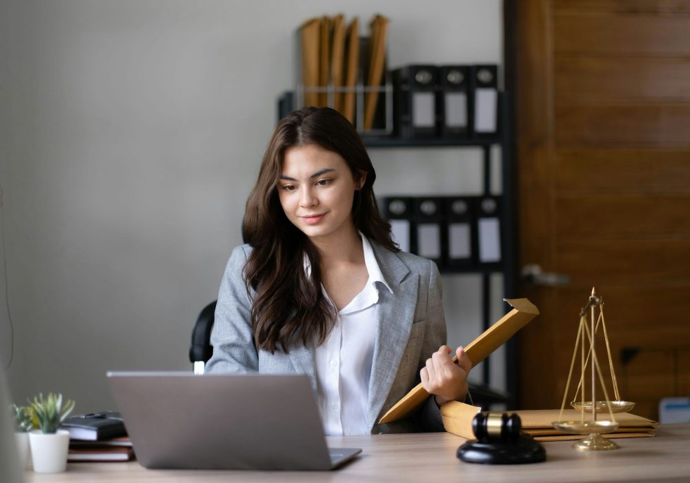 Asian lawyer woman working with a laptop computer in a law office. Legal and legal service concept.